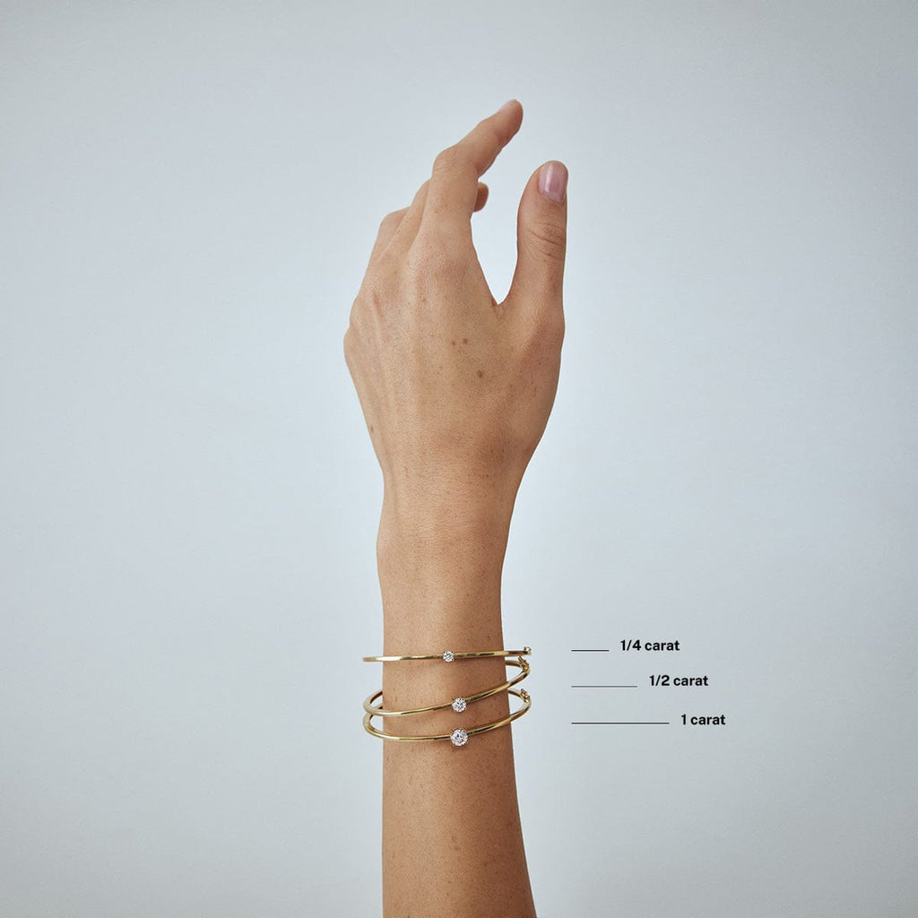 compare round diamond carat weight bracelets on model's wrist arm