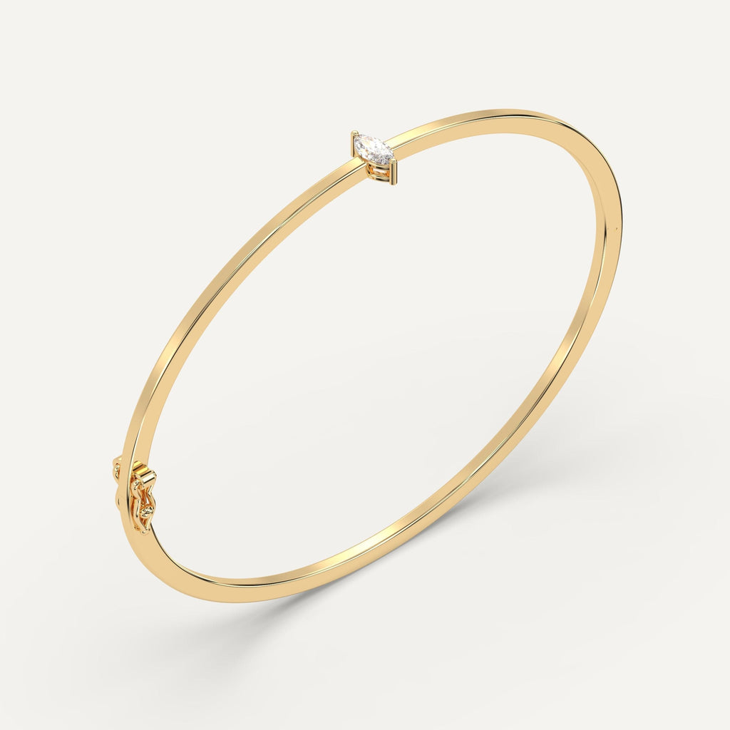 yellow gold solitaire, bangle bracelets with 1/4 carat marquise diamonds