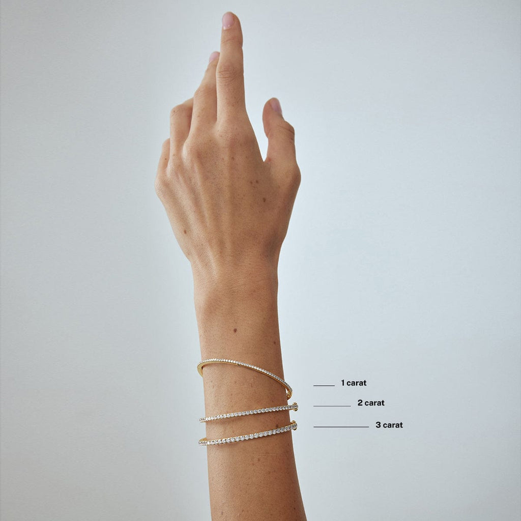 Compare 2 carat diamond bangle bracelet in white gold on model's wrist arm