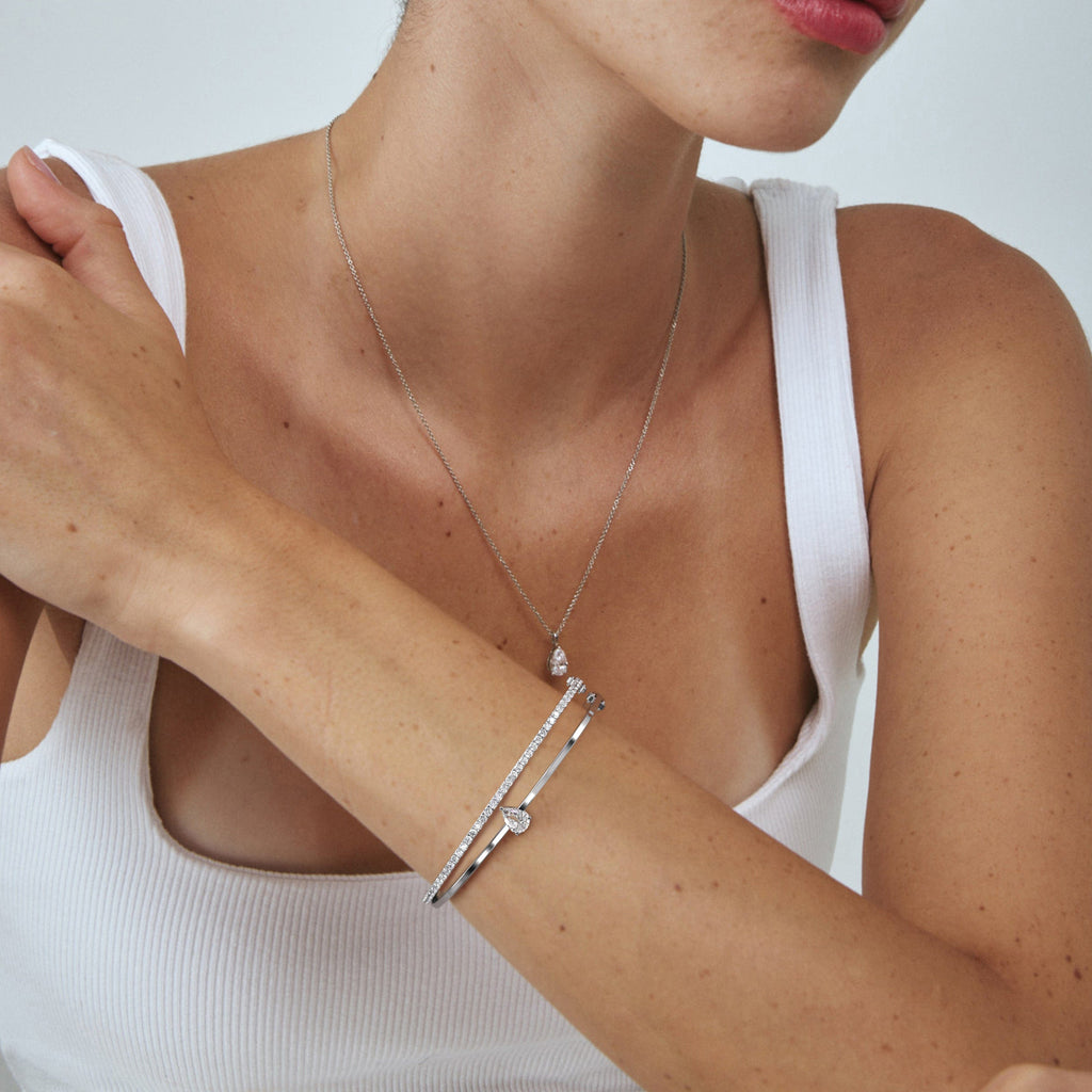 1 1/2 carat diamond bangle bracelet in white gold on model's wrist arm