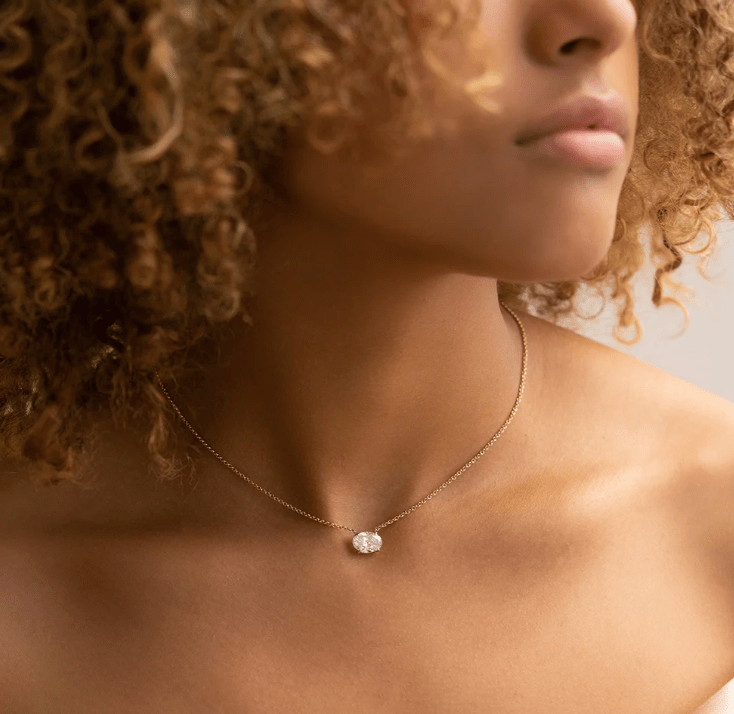 2 carat oval diamond necklace floating horizontal on model