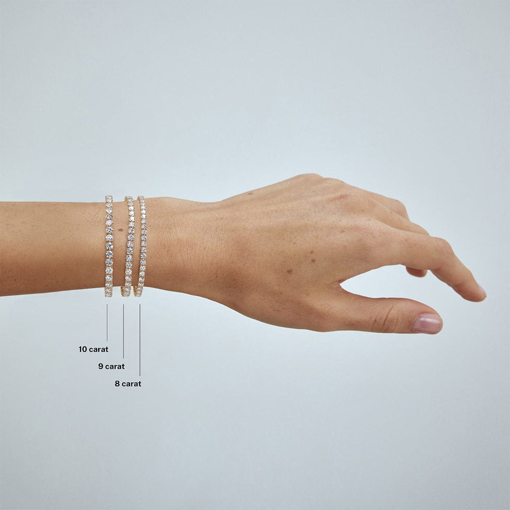 compare 4 carat, 5 carat, 6 carat and 7 carat diamond tennis bracelets on model's wrist arm