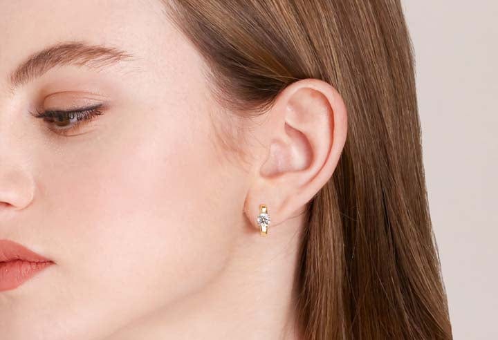 Yellow gold moissanite hoop earrings on model