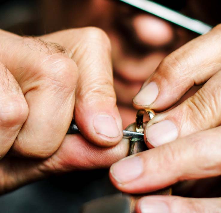 Jeweler working on a yellow gold wedding ring