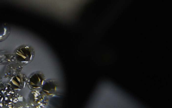 Round shaped diamonds through a jeweler's loupe