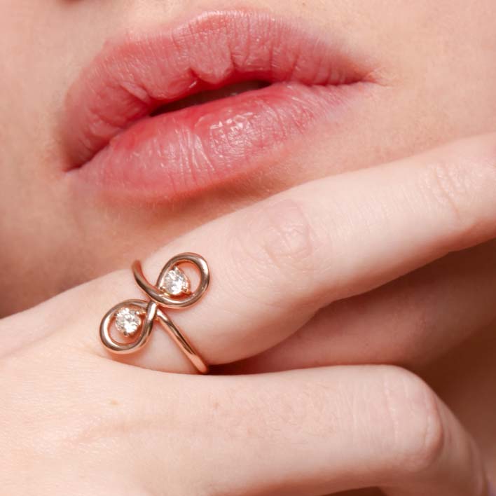 Close up of infinity promise ring on model