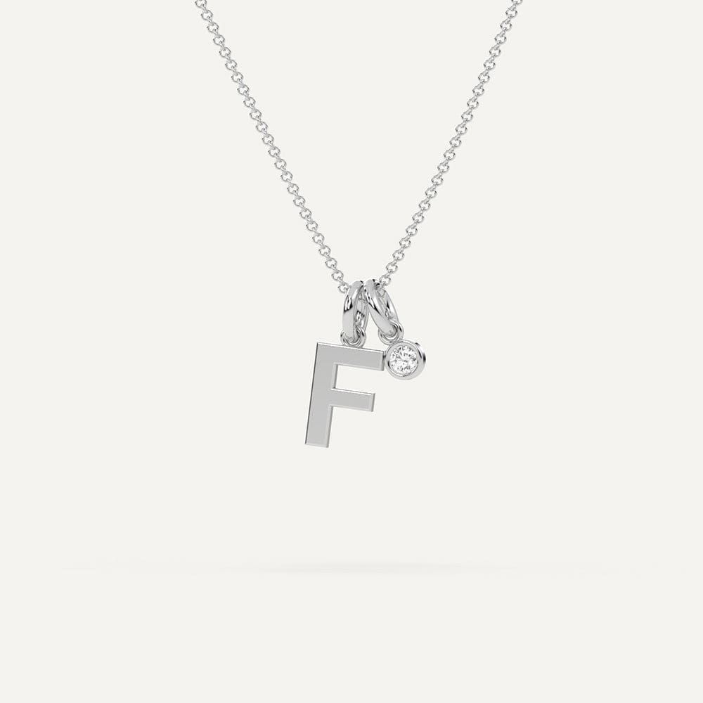 Gold initial letter F necklace with sparkling diamond accent on delicate chain.