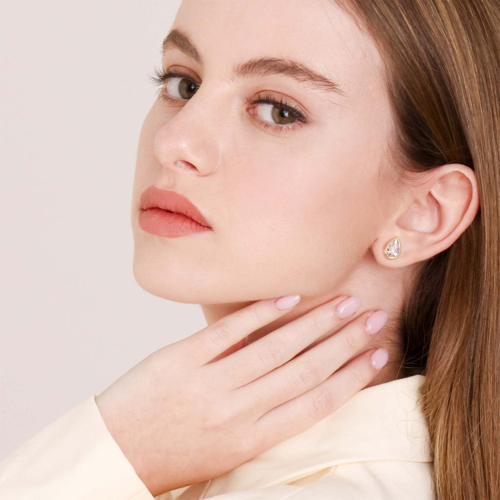 Yellow Gold Bezel Set Pear Shaped Diamond Earrings on Ear